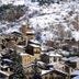 Hostal la Font in Os de Civís, snowy village buildings on a mountainside