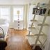 Desoto Beach Terraces in Tybee Island: bright guest room with twin bed, wood floors, dresser and shelves