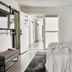 Bluebird Spa City Motor Lodge in Saratoga Springs: bright guest room with bed, open door, and hallway view