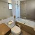 Hotel Los Españoles Plus bathroom in Santiago with bathtub, shower, toilet and stone tile walls