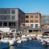Hammetts Hotel in Newport with marina boats docked in front of the waterfront building