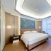 Shengshi Civil Aviation Hotel Zhengzhou guest room with king bed, desk, chairs and large window