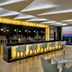 Hilton Hurghada Plaza bar lounge with floor-to-ceiling windows and sunset sea view in Hurghada