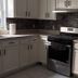 Nwk 457 Room 111-A in Newark kitchen with stainless steel stove, fridge and white cabinets