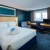 Travelodge London Kingston Upon Thames room with double bed, desk, and window view