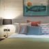 Chainlocker Falmouth guest room with double bed, lamps and whale wall art