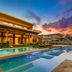 Kaya Palazzo Golf Resort in Belek with a luxury outdoor pool and modern resort architecture at sunset