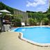 Wild Orchid Villa Bangkok in Bangkok with a curved outdoor pool surrounded by lounge chairs and lush greenery