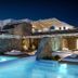 Balius Mykonos in Mykonos with illuminated infinity pools and luxury cabanas at night