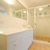 Bathroom at Beach Court Holiday Villas in Airlie Beach with vanity, mirror and glass shower