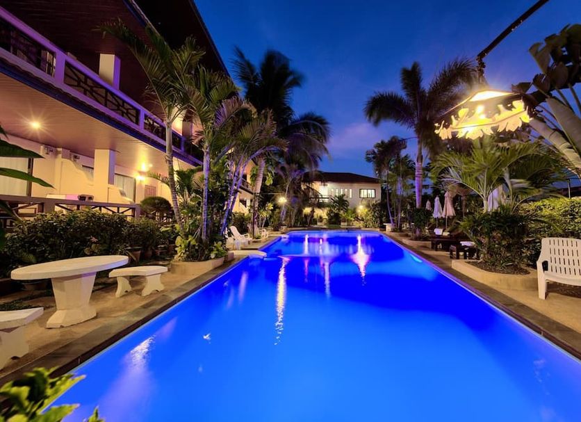 Aumpai Luxury in Ko Samui, illuminated pool surrounded by tropical palms at dusk