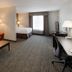 Holiday Inn Express & Suites East Wichita I-35 Andover By IHG guest room with bed, sofa, desk and window