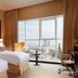 Jannah Burj Al Sarab, Abu Dhabi guest room with twin beds and city skyline view