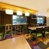 Fairfield Inn by Marriott Orangeburg breakfast area with tables, chairs, and colorful carpet