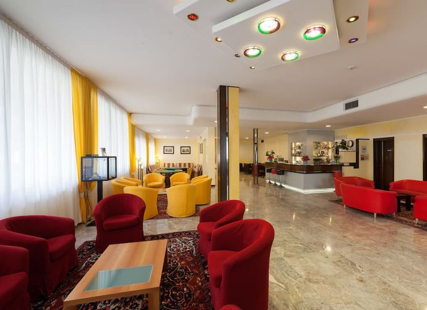 Hotel Terme Vena D'Oro lobby in Abano Terme with red and yellow seating and bar area