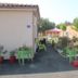 La Garona in Saint-Nicolas-de-la-Grave with a small garden patio, tables, chairs and potted plants
