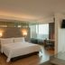 Fiesta Inn Morelia Altozano guest room with king bed, desk, TV, and city view in Morelia