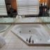 Mackinaw Budget Inn in Mackinaw City bathroom with corner whirlpool tub and mirrored wall