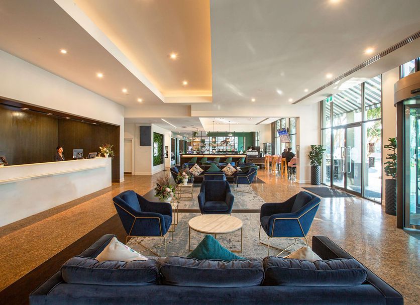 Novotel Melbourne Glen Waverley lobby lounge with seating and front desk in Glen Waverley