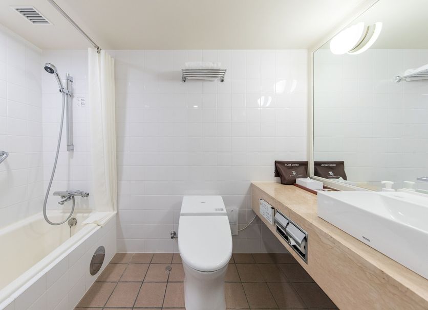 Jr Kyushu Hotel Blossom Fukuoka bathroom with bathtub, shower, toilet and vanity in Fukuoka