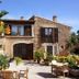 Finca Sa Carrotja in Ses Salines, stone hotel exterior with terrace, potted plants and colorful flowers