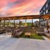 Cambria Hotel Austin Airport rooftop terrace with lounge seating and sunset sky in Austin