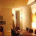 Art Hotel Aos Sinos Dos Anjos in Arraial d'Ajuda, warmly lit dining area with wooden tables and chairs