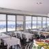 Hotel Caravelle in Jesolo dining room with large windows overlooking beach umbrellas and sea
