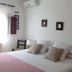 Agroturismo Ca Sa Vilda Marge bedroom in Sant Joan de Labritja with bed, pillows, bedside lamps and wall art