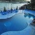 Ganga Beach Resort in Rishikesh with a riverside pool and blue loungers overlooking the water