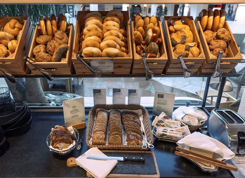 Breakfast buffet at Waldhof Fuschlsee Resort in Fuschl am See with bread baskets and pastries