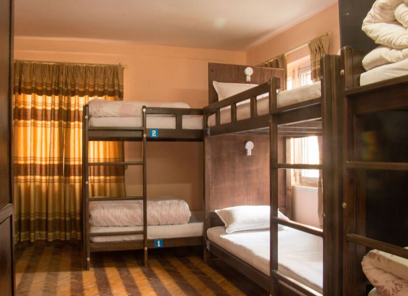 Hostel Himalaya, Kathmandu: dorm room with bunk beds and stacked towels by the window