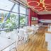 Travelodge Hull Central dining area with white tables, chairs, wood floors and large windows