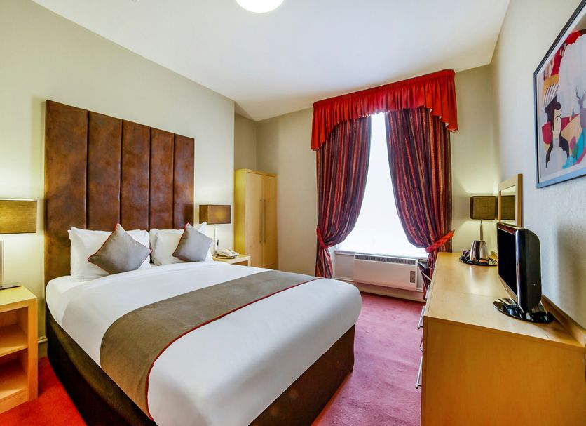 Brentwood Aberdeen City Centre near Union Street guest room with king bed and red curtains in Aberdeen