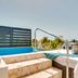Las Terrazas Resort in San Pedro Town: rooftop plunge pool with ocean view and sun loungers
