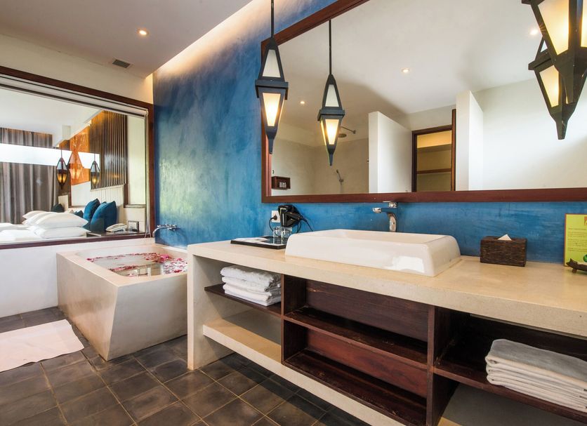 Metta Residence & Spa, Siem Reap: modern bathroom vanity with vessel sink, mirror, and deep soaking tub