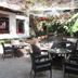 Hôtel du Roi Christophe in Cap Haitien courtyard with outdoor tables, chairs and tropical greenery