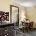 Guest room at Red Roof Inn Vincennes with TV, desk, mirror, and lamp in Vincennes.