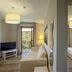 Valle Del Buttero in Capalbio: bright suite with sofa, TV, balcony door, and separate bedroom