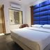 Sri Nanak Continental Hotel, New Delhi guest room with king bed and blue padded headboard