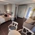 Theoxenia Caldera Hotel in Thera bedroom with twin beds, sofa, wardrobe, mirror and chair seating