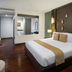 Centara Anda Dhevi Resort & Spa Krabi room with king bed, bedside lamps, and dark wood floor in Ao Nang