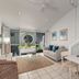 Caribbean Noosa in Noosa Heads: bright loft living area with sofa, desk, and balcony doors