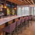 Courtyard by Marriott Fairfax Fair Oaks bar lounge with marble counter, stools, and seating area in Fairfax