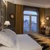 Relais & Châteaux Heritage Hotel Madrid guest room with king bed, city-view windows and desk