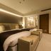Hotel Nikko Tsukuba in Tsukuba: modern twin bed room with upholstered benches and warm lighting