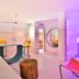 Paradiso Ibiza Art Hotel - Adults Only room with neon lighting, bed, seating, and round mirror in Sant Josep de sa Talaia