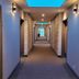 Quality Inn Nanaimo hallway with guest room doors and blue ceiling light panels