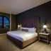 Hotel Vin, Grapevine, Autograph Collection guest room with arched window city view and king bed