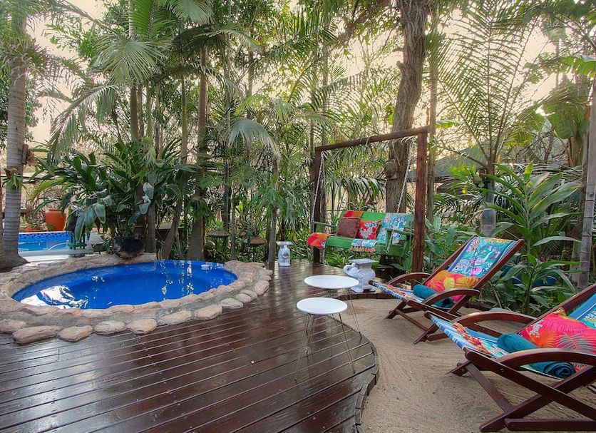 Kruger Wielewaal Restcamp in Marloth Park: tropical deck with small plunge pool and colorful loungers